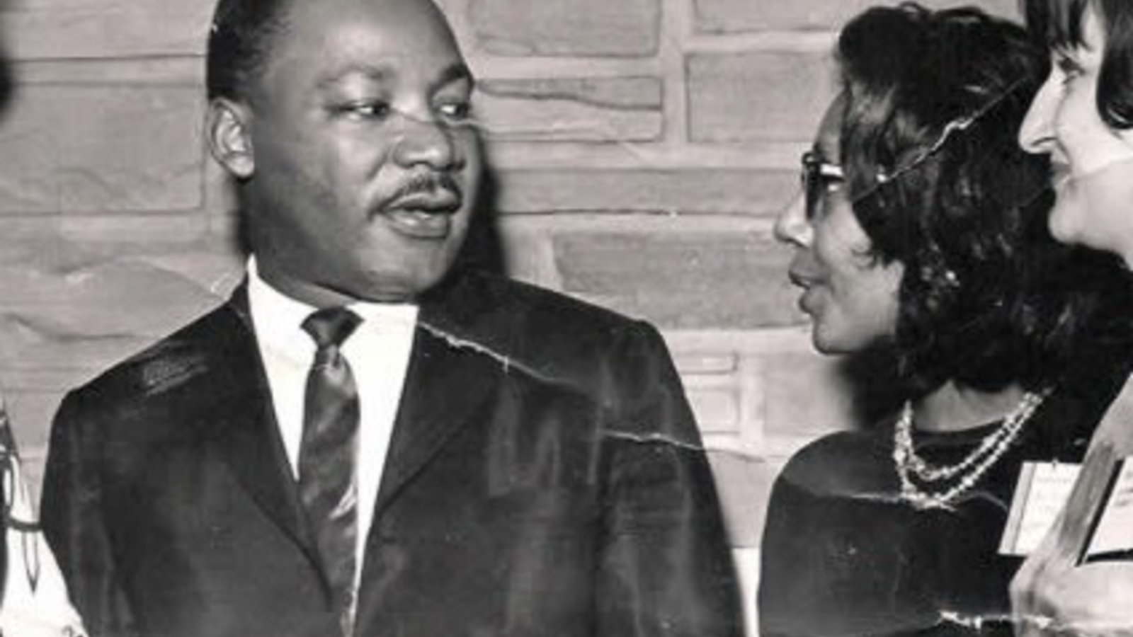 A black and white photograph of Alice Tregay speaking with Dr. Martin Luther King, Jr.