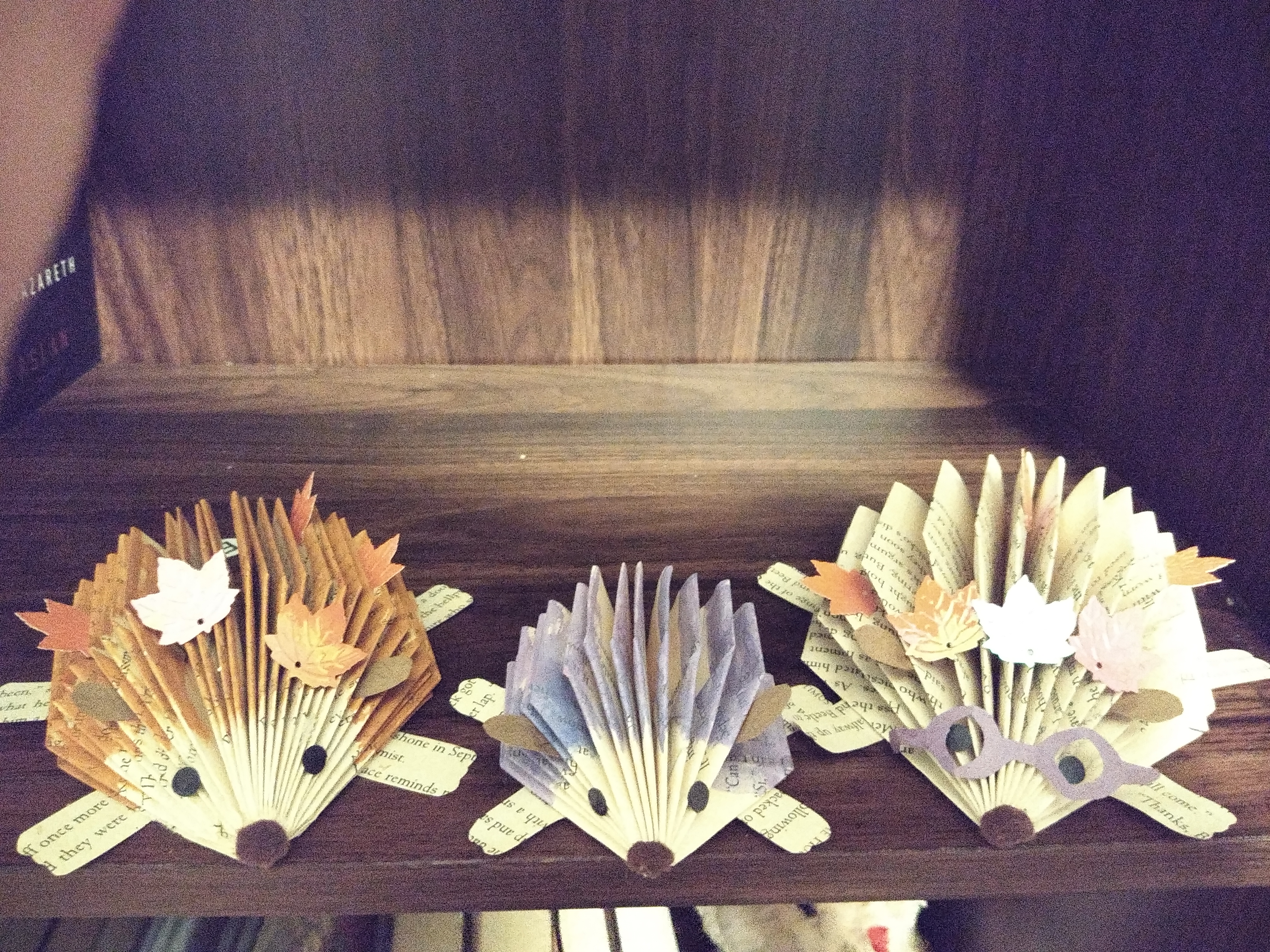 Three paper hedgehogs made out of recycled books. 