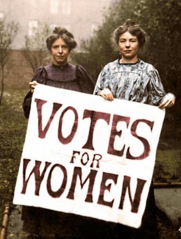 Image of two women holding a "Votes For Women" Sign