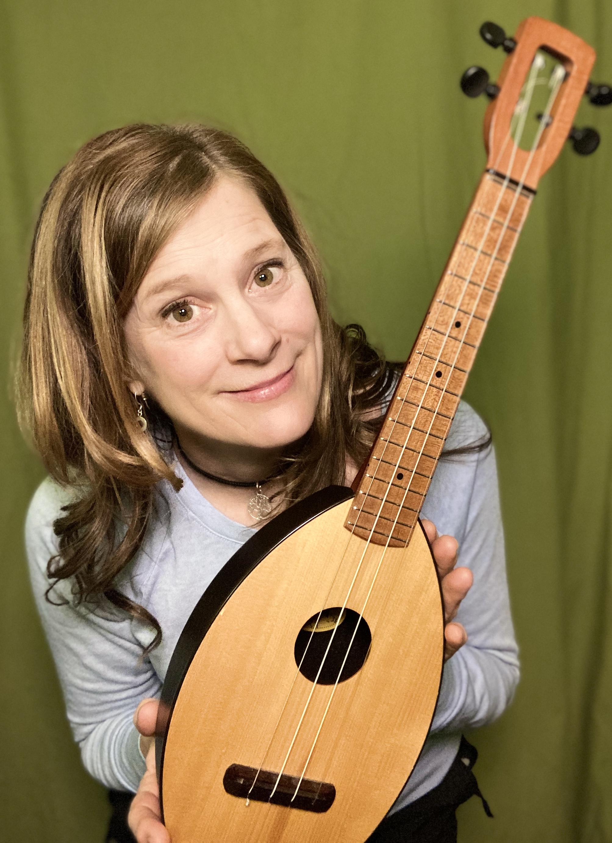 Julie Stepanek posing with a ukulele