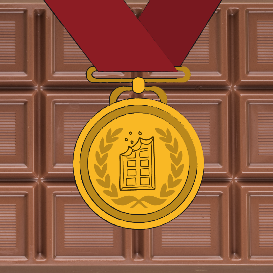 A gold medal with a chocolate bar engraved on the front. The background of the image is a bar of of chocolate.