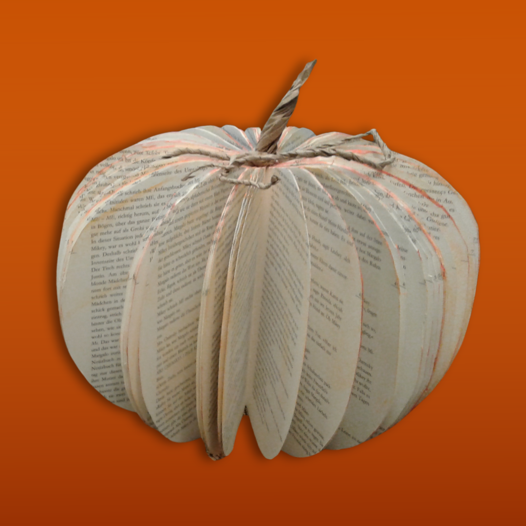 A pumpkin made out of an old book; it is pumpkin shaped, and formed by fanned out pages