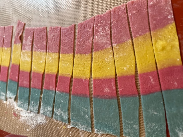 A sample of rainbow pasta, colored red blue and yellow