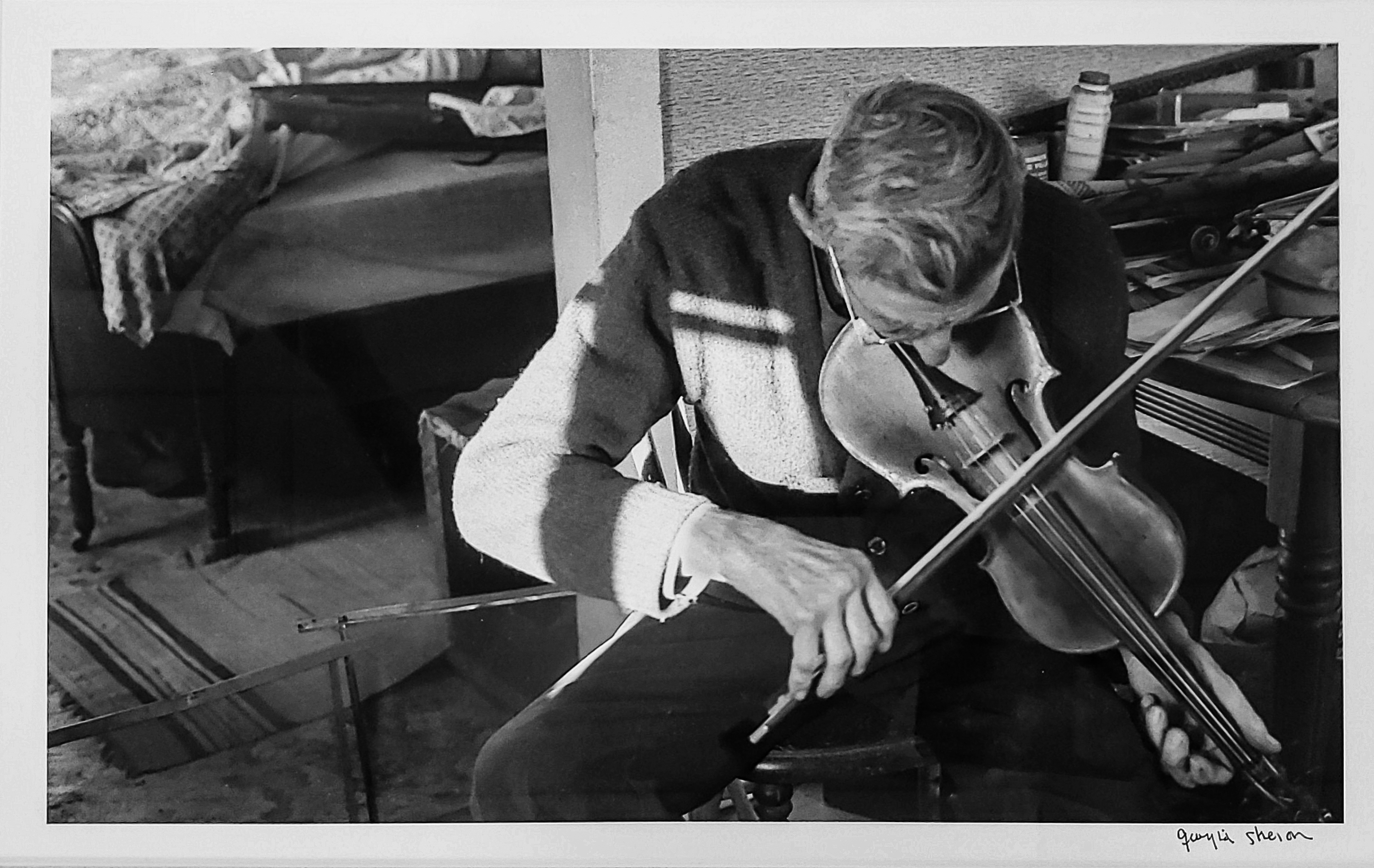 Image of a man playing a violin
