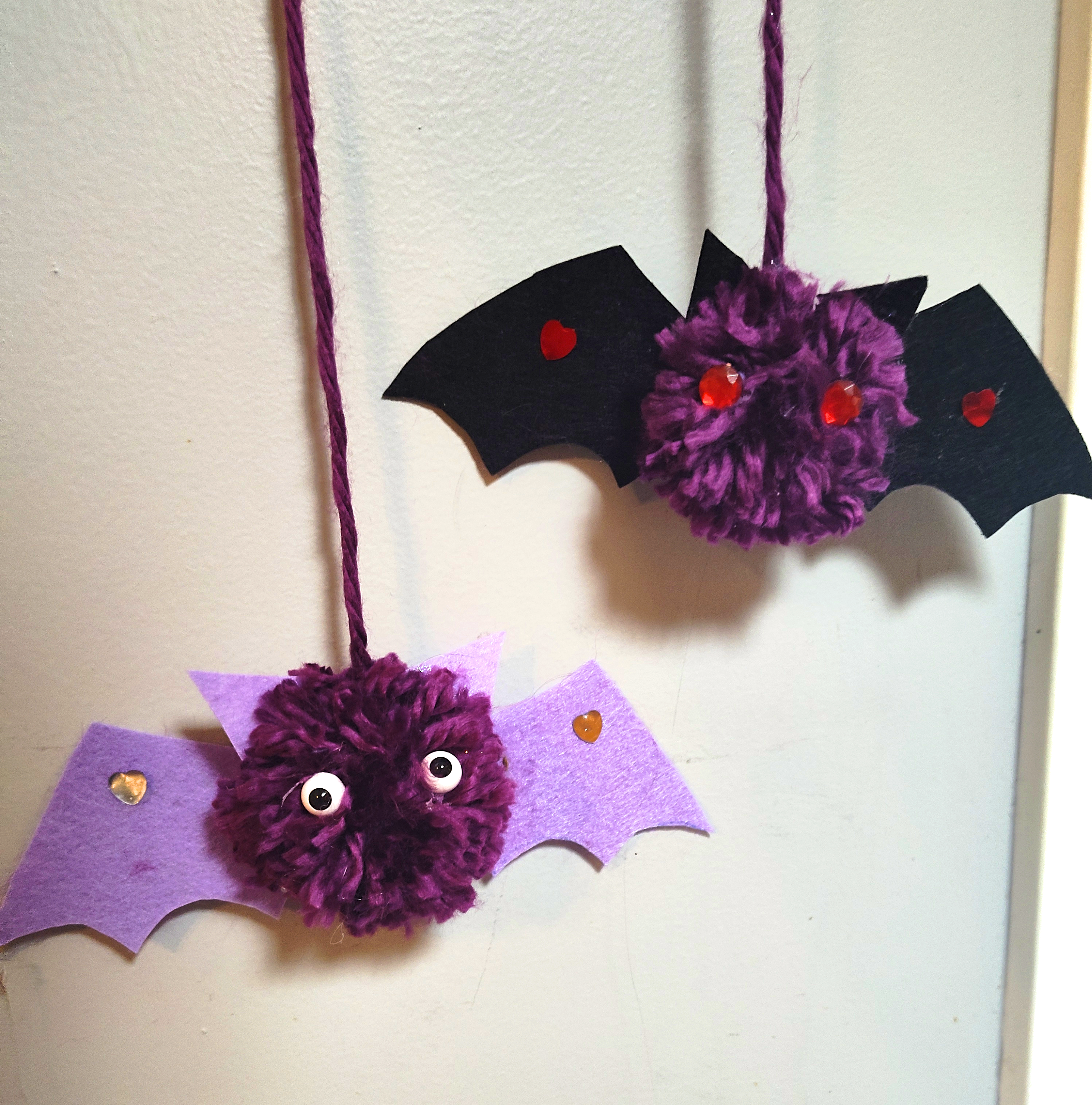 A sample of the craft featuring two purple pom pom bats