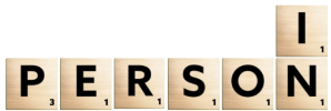 Scrabble tiles spelling "In Person"