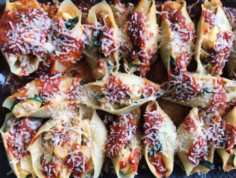 Shells stuffed with veggies and tomato sauce and baked with cheese