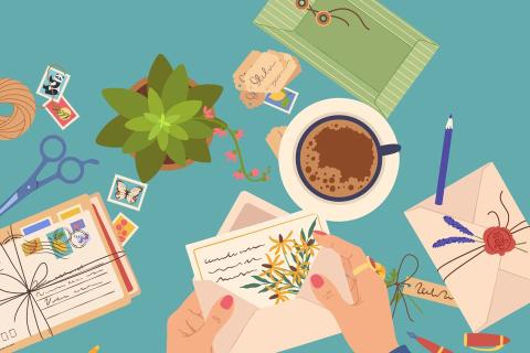 an illustration of a desktop with letter writing materials on top