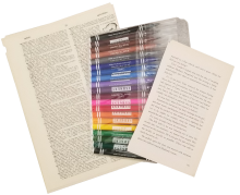 A package of markers arranged with two different sized stacks of book pages, one large and the other smaller.
