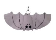 A smiling bat plush with its wings spread