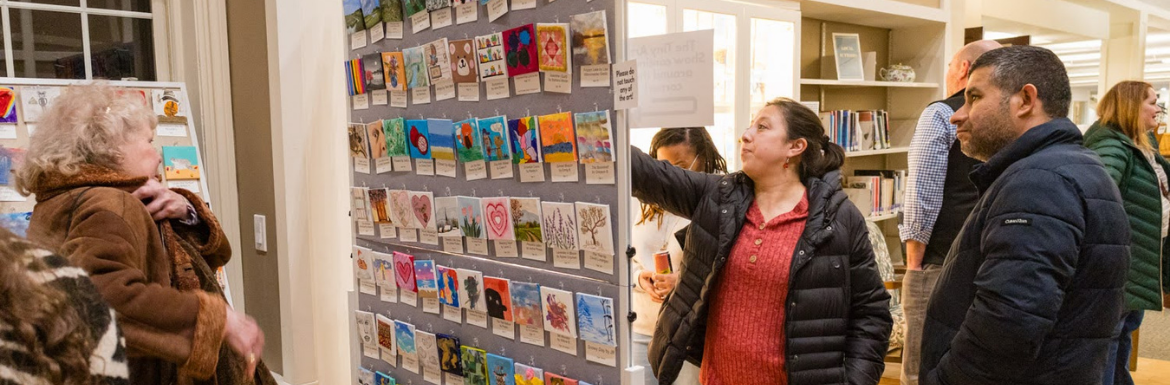 People looking at the Tiny Art on Display