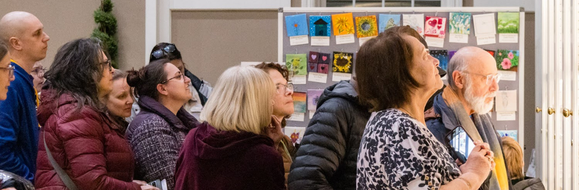 People looking at the Tiny Art on Display
